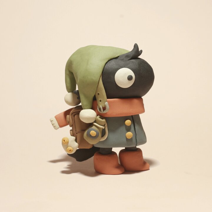 Image of a little clay charater looking to the right