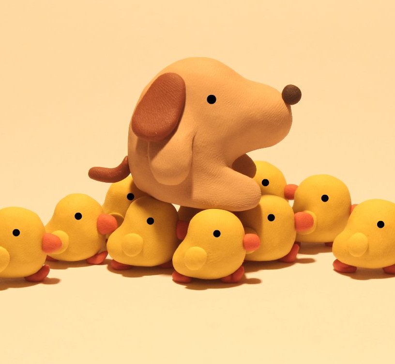 Image of a little clay dog being carried away by little clay chicks